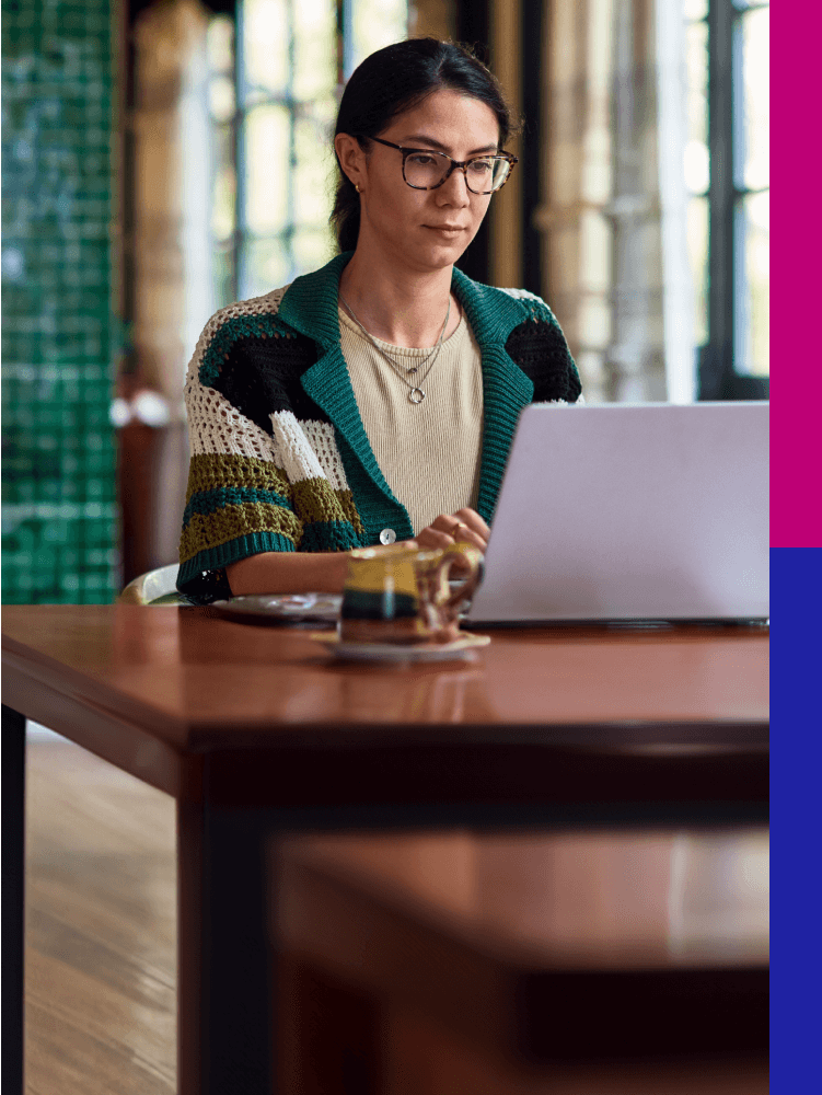 Photo of woman in glasses working on a laptop