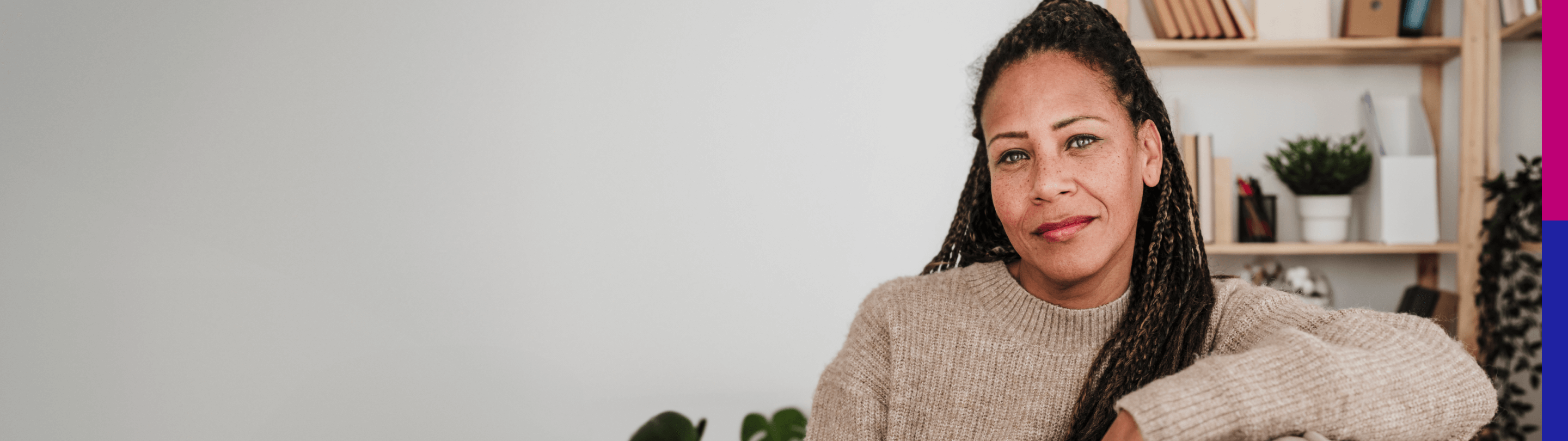 Photo of a woman looking at the camera while sitting down in an office